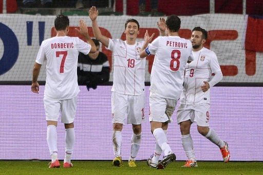 Filip Duricic (centre) celebrates Serbia's third goal against Chile in St Gallen on November 14, 2012